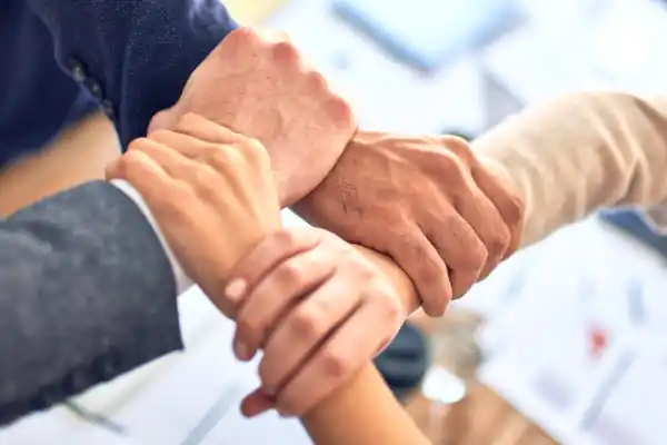 four hands together